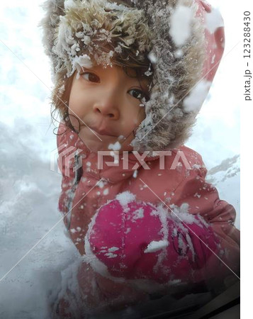 雪の外遊び中にこちらを見上げる女の子 123288430