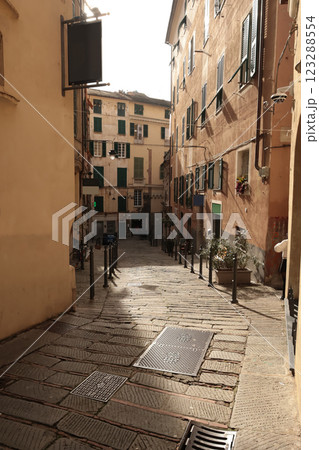 Traditional buildings and steps, pedestrianized narrow streets of old town. Genoa and medieval architecture of Italy. Windows and doors.  123288554