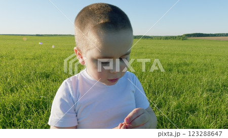 Saying Boy. Boy Tell Story Or Ask Some Question. Child Speaks. Portrait Of Happy Little Kid On Blue Sky Background. Speaks With Genuine Emotion And Enthusiasm. Gimbal shot. Saying Boy. Boy Tell Story Or Ask Some Question. Child Speaks. Portrait Of Happy Little Kid On Blue Sky Background. Speaks With Genuine Emotion And Enthusiasm. Gimbal shot. 123288647