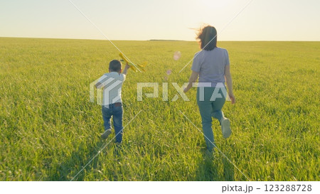 Happy Kid Run In Field With Toy Airplane Against Sky. Boy Launches An Airplane. Happy Child With Toy Airplane. Little Boy With Toy Plane Outdoors. Gimbal shot. Happy Kid Run In Field With Toy Airplane Against Sky. Boy Launches An Airplane. Happy Child With Toy Airplane. Little Boy With Toy Plane Outdoors. Gimbal shot. 123288728