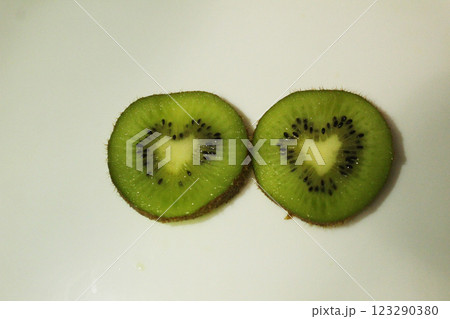 Kiwi in a heart-shaped cut on a white background, top view. Fruit Heart Kiwi in a heart-shaped cut on a white background, top view. Fruit Heart 123290380