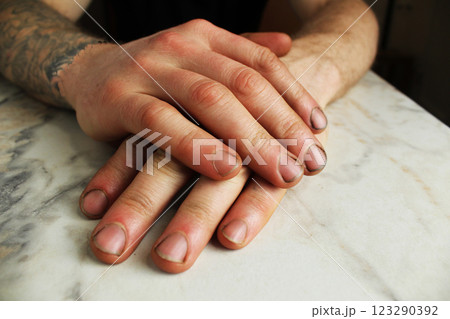 Male hands on the table lying on top of each other close-up 123290392
