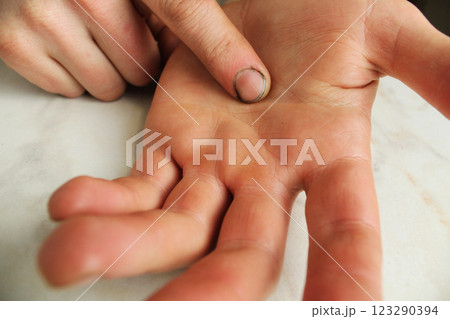 The man points his finger at the palm of his hand. Abuser 123290394