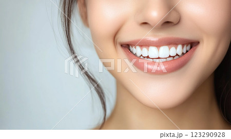 Close-up of a person's face showcasing a bright, white smile with healthy gums and a natural skin tone. Aesthetic dental care is shown. 123290928