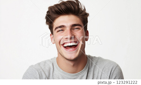 Radiant joy captured in a bright smile, showcasing infectious laughter and a carefree spirit in a simple studio setting. 123291222