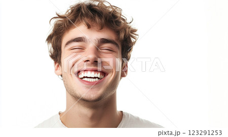 Joyful smile of a young man with curly hair, eyes closed, radiating happiness and positive emotion, against a bright white backdrop. Joyful smile of a young man with curly hair, eyes closed, radiating happiness and positive emotion, against a bright white backdrop. 123291253