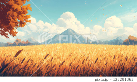 Golden wheat field under a blue sky with clouds, distant mountains, and falling leaves on an autumn day in a serene landscape. 123291363