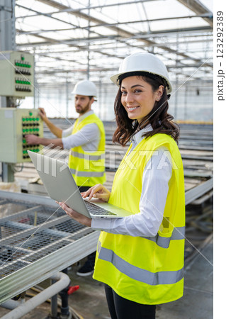 Young female engineer with a laptop checking the parameters at the construction site Young female engineer with a laptop checking the parameters at the construction site 123292389
