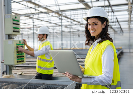 Young female engineer with a laptop checking the parameters at the construction site Young female engineer with a laptop checking the parameters at the construction site 123292391