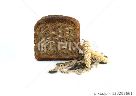 A nutritious slice of multigrain bread featuring an array of seeds and a single sprig of wheat. A nutritious slice of multigrain bread featuring an array of seeds and a single sprig of wheat. 123292661