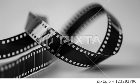 Film strip swirling against a bright background in a creative display. Generative AI 123292790