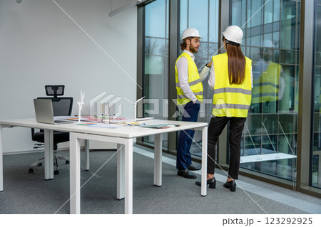 Two engineers working in the office on a new green energy project 123292925