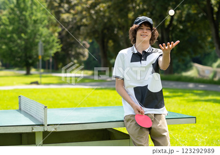 Guy in black cap playing table tennis and looking enjoyed 123292989