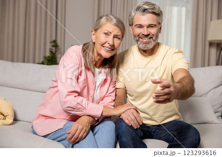 Mature happy couple spending time at home and looking excited 123293616