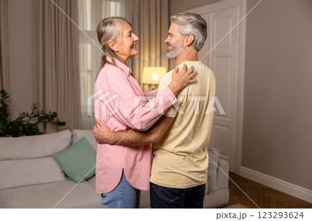 Happy mature couple dancing at home and feeling romantic Happy mature couple dancing at home and feeling romantic 123293624