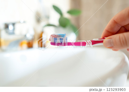 Toothpaste on a toothbrush contains natural salt, helps remove plaque, and strengthens gums. Free from fluoride and artificial additives. Toothpaste on a toothbrush contains natural salt, helps remove plaque, and strengthens gums. Free from fluoride and artificial additives. 123293903