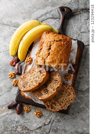 Date banana nuts diet bread close-up on wooden board. Vertical top view Date banana nuts diet bread close-up on wooden board. Vertical top view 123294418