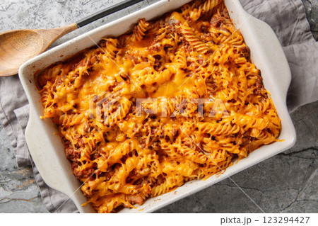 Homemade Sloppy Joe Casserole with ground beef, pasta and gooey cheddar cheese and baked to perfection in the oven closeup in the baking dish. Horizontal top view Homemade Sloppy Joe Casserole with ground beef, pasta and gooey cheddar cheese and baked to perfection in the oven closeup in the baking dish. Horizontal top view 123294427