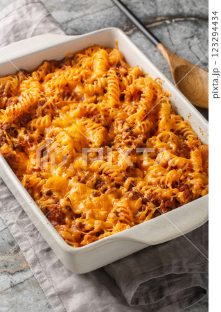 Sloppy Joe Casserole is loaded with juicy ground beef and pasta smothered in a cheesy sauce closeup in the baking dish. Vertical Sloppy Joe Casserole is loaded with juicy ground beef and pasta smothered in a cheesy sauce closeup in the baking dish. Vertical 123294434