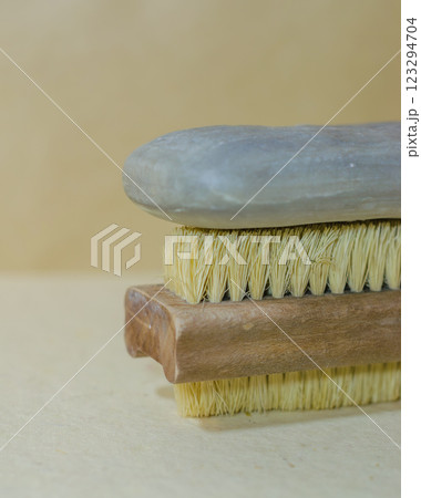 Natural soap bar placed on a wooden cleaning brush with stiff bristles. High quality photo 123294704