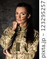 Beautiful military woman in Ukrainian military uniform with camouflage makeup on her face 123295257