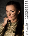 Military woman in Ukrainian military uniform with camouflage makeup on her face 123295258
