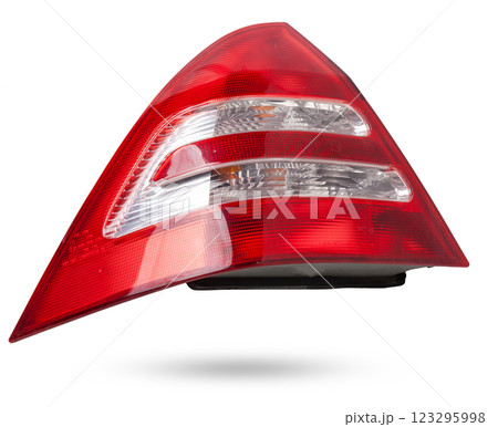 A taillight of a stop signal for a German auto - optical equipment of white and red color on a white isolated background. A spare part for repair and sale in a car service center. A taillight of a stop signal for a German auto - optical equipment of white and red color on a white isolated background. A spare part for repair and sale in a car service center. 123295998