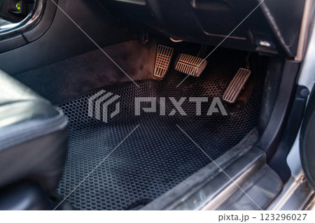 Close-up of a clean black rubber auto mat under a passenger seat in an old Russian car after dry cleaning. 123296027