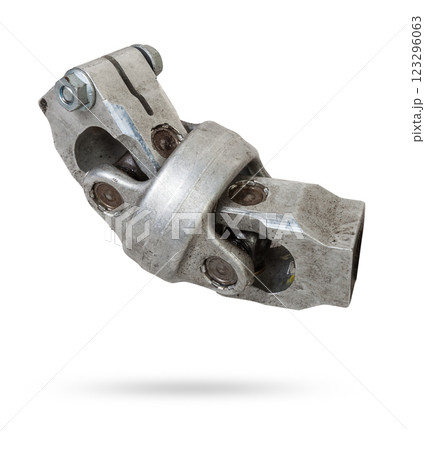The spare part of the car is a metal steering propeller shaft with hinges on a white background with inscriptions designating the model. Repair of equipment at the auto-parsing in the workshop. 123296063
