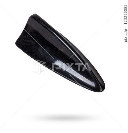 Black plastic fin-shaped antenna for installation on the roof of a car and transmitting a radio signal on a white isolated background. Auto spare parts catalog. Black plastic fin-shaped antenna for installation on the roof of a car and transmitting a radio signal on a white isolated background. Auto spare parts catalog. 123296083