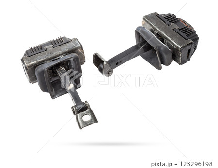 Metal and plastic car spare parts on a white isolated background - door stopper that prevents hard touches of body elements, damage or breakage. Detail of a mechanical assembly. 123296198