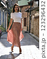 Beautiful woman 51 years old in a light long skirt posing in the morning sunshine in the Old Town in Antalya Turkey 123296432