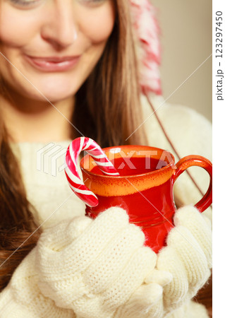 Girl hands holding mug and cane. Girl hands holding mug and cane. 123297450