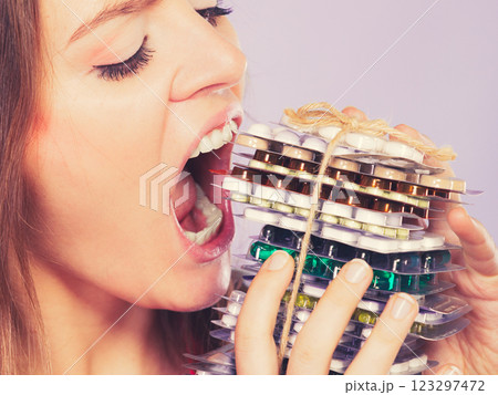 Woman taking eating pills tablets. Drug addict. 123297472