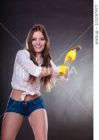 Sexy alluring woman holding hammer. Feminism. Sexy alluring woman holding hammer. Feminism. 123297477