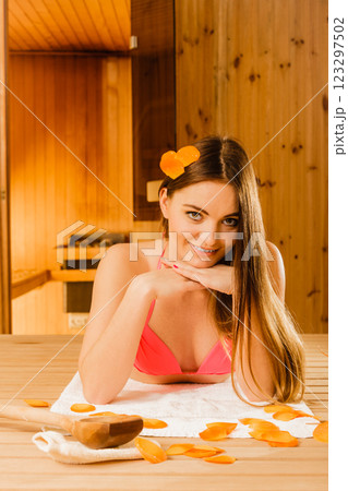Young woman relaxing in sauna. Spa wellbeing. 123297502