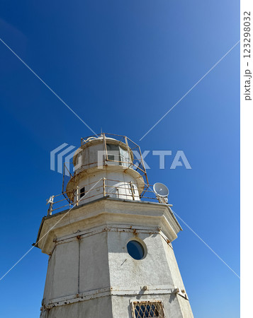 Coastal Lighthouse for Navigation on Blue Sky Background 123298032