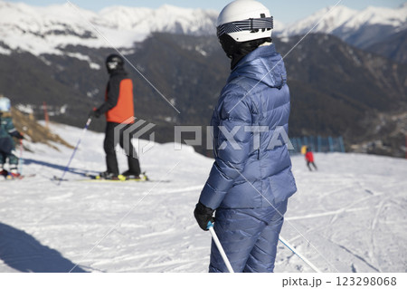 Skiers and snowboarders ride on a mountain ski track with snow 123298068