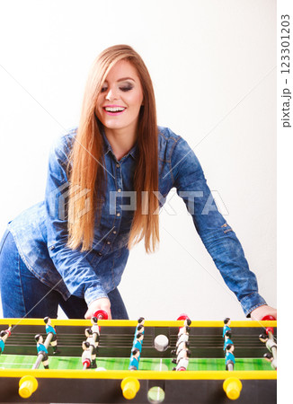 woman playing table football game woman playing table football game 123301203