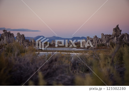 Scenic view of Mono Lake tufas at sunset with distant mountains in California, USA. Concept of nature, landscape, and geological formations. 123302280