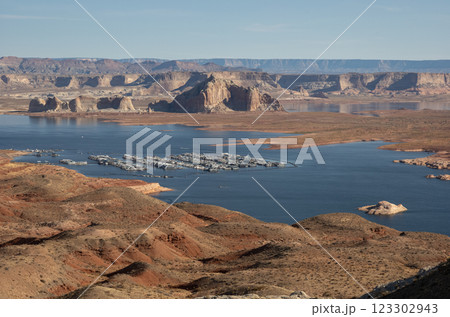 Scenic aerial view of Lake Powell with houseboats docked at the marina, surrounded by desert landscape and rock formations. Concept of water recreation, tourism, and drought awareness 123302943