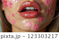 Close-up of beautiful aesthetic lips with red lipstick filled with decorative flowers around, sexy and sensual 123303217