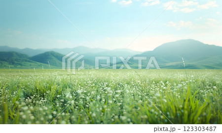 A serene outdoor summer peaceful refreshing greenery landscape field of blooming flowers wildflowers lush green grass on mountains soft sunlight, gentle breeze carries sense of tranquility and joy 123303487