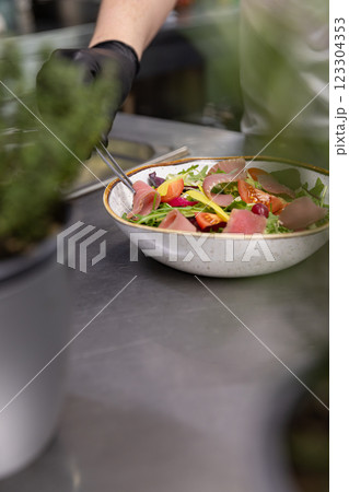 Chef holding gourmet salad Chef holding gourmet salad 123304353