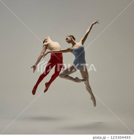 Elegant ballet moment captured mid-movement, highlighting form, control, and expressive artistry against white studio background. Concept of ballet and art 123304493