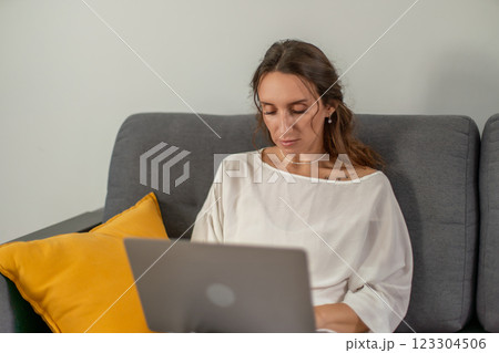 Woman Laptop Home Office: Working remotely on laptop indoors, contemporary lifestyle. 123304506
