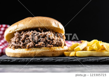 Traditional sloppy joe sandwich with french fries on wooden table Traditional sloppy joe sandwich with french fries on wooden table 123305723