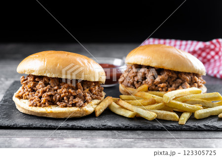 Traditional sloppy joe sandwich with french fries on wooden table Traditional sloppy joe sandwich with french fries on wooden table 123305725