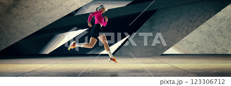 Banner. Composite collage of focused on victory woman sprinting with intensity through urban, futuristic city environment. Champion spirit. 123306712