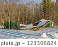 Old green barn collapses due to age and heavy snow load in winter 123306824